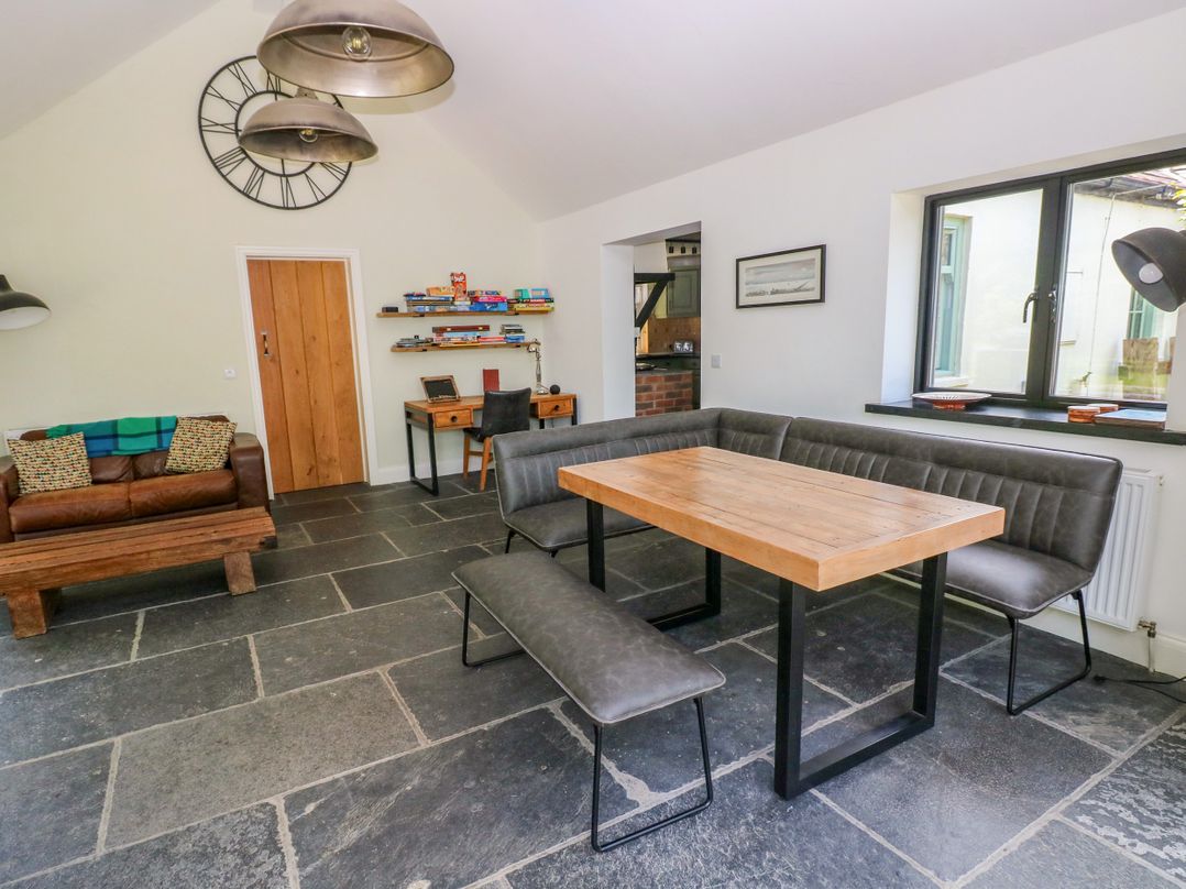 A dining room with a table and seating at Glas y Dorlan Nevern near Newport, Pembrokeshire