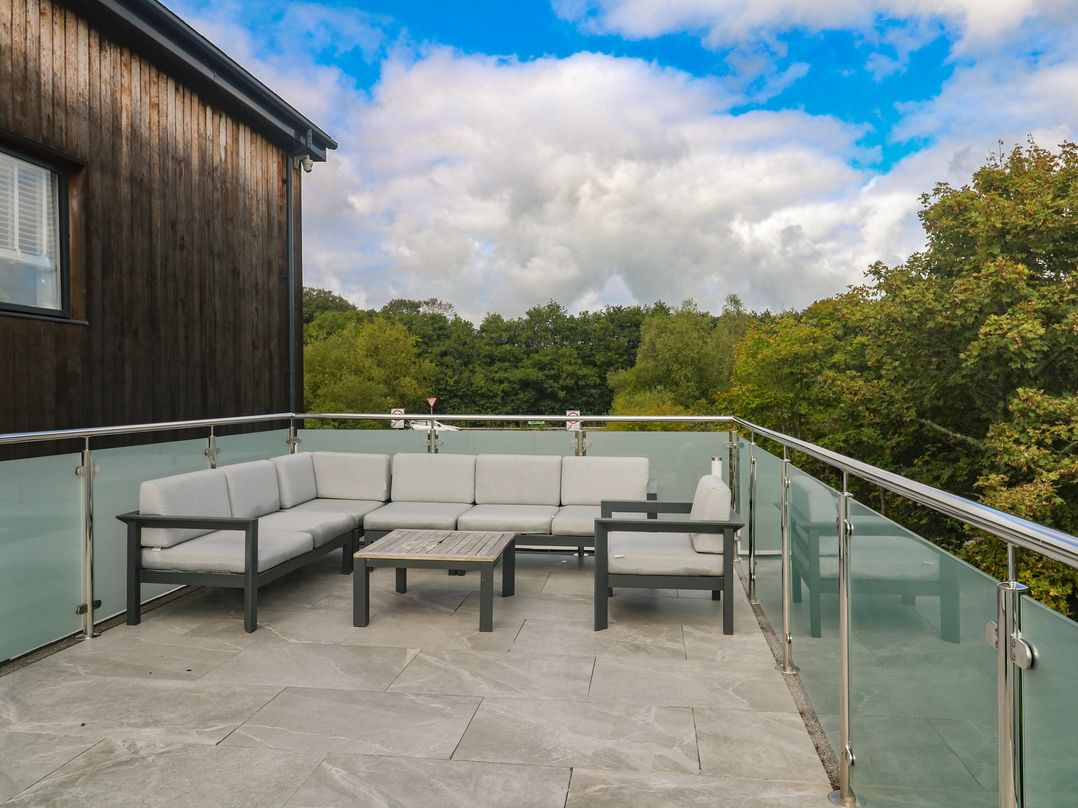 A terrace with seating area and table at Carnon Gwel, Devoran