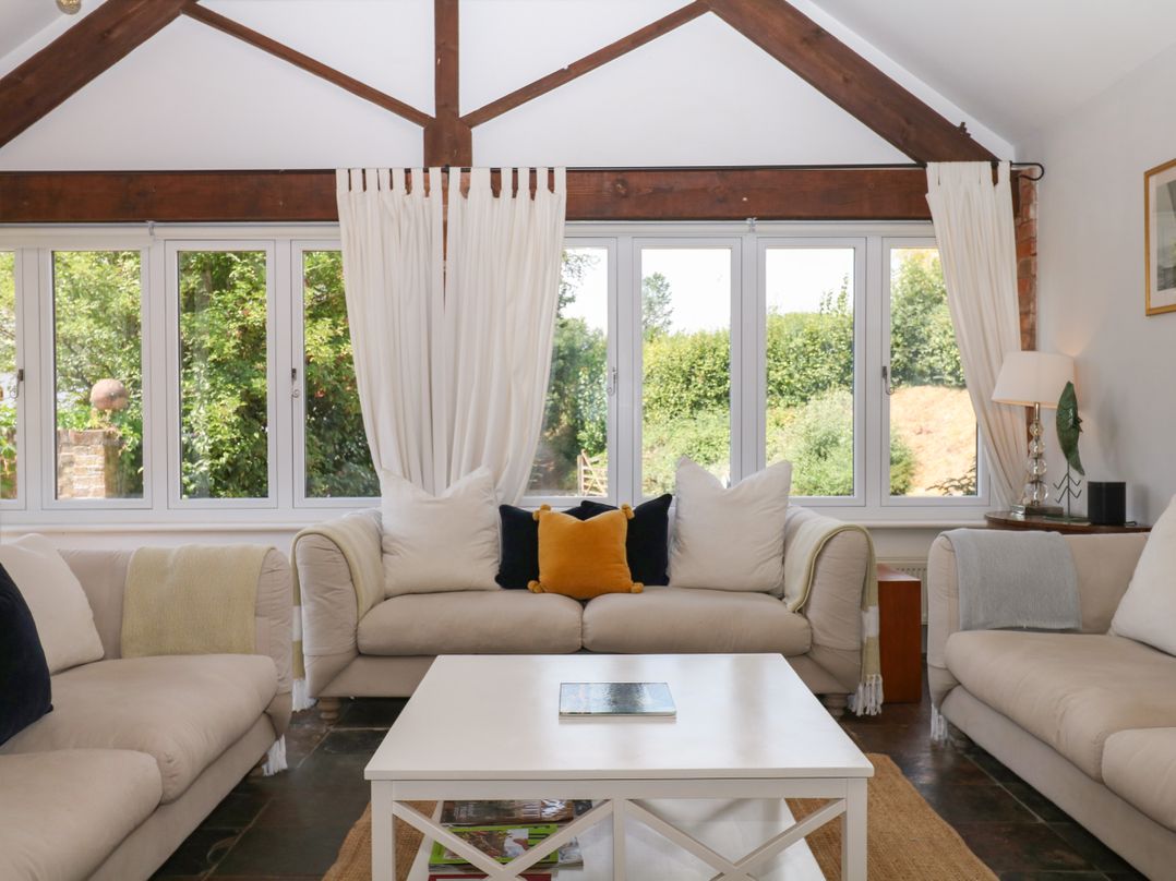 A living room with sofas and a coffee table at Apple Mill in Venn Ottery near Sidmouth
