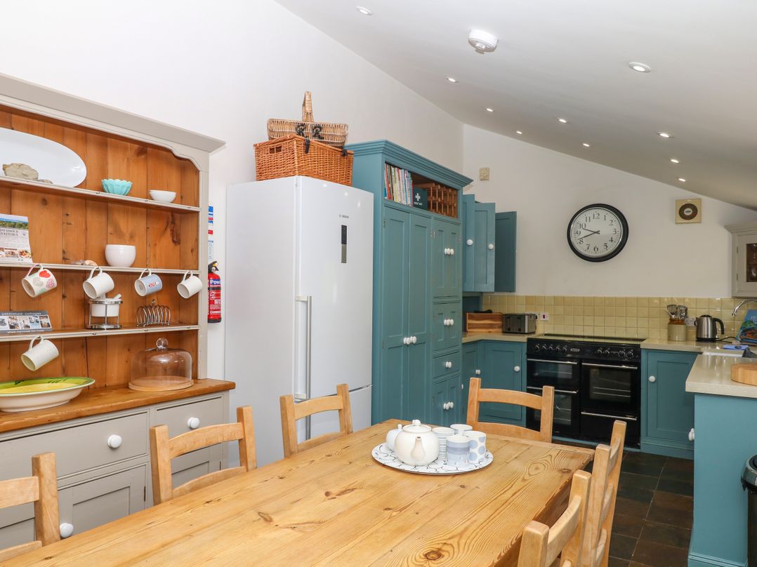 A kitchen with a table and chairs at Apple Mill Venn Ottery near Sidmouth