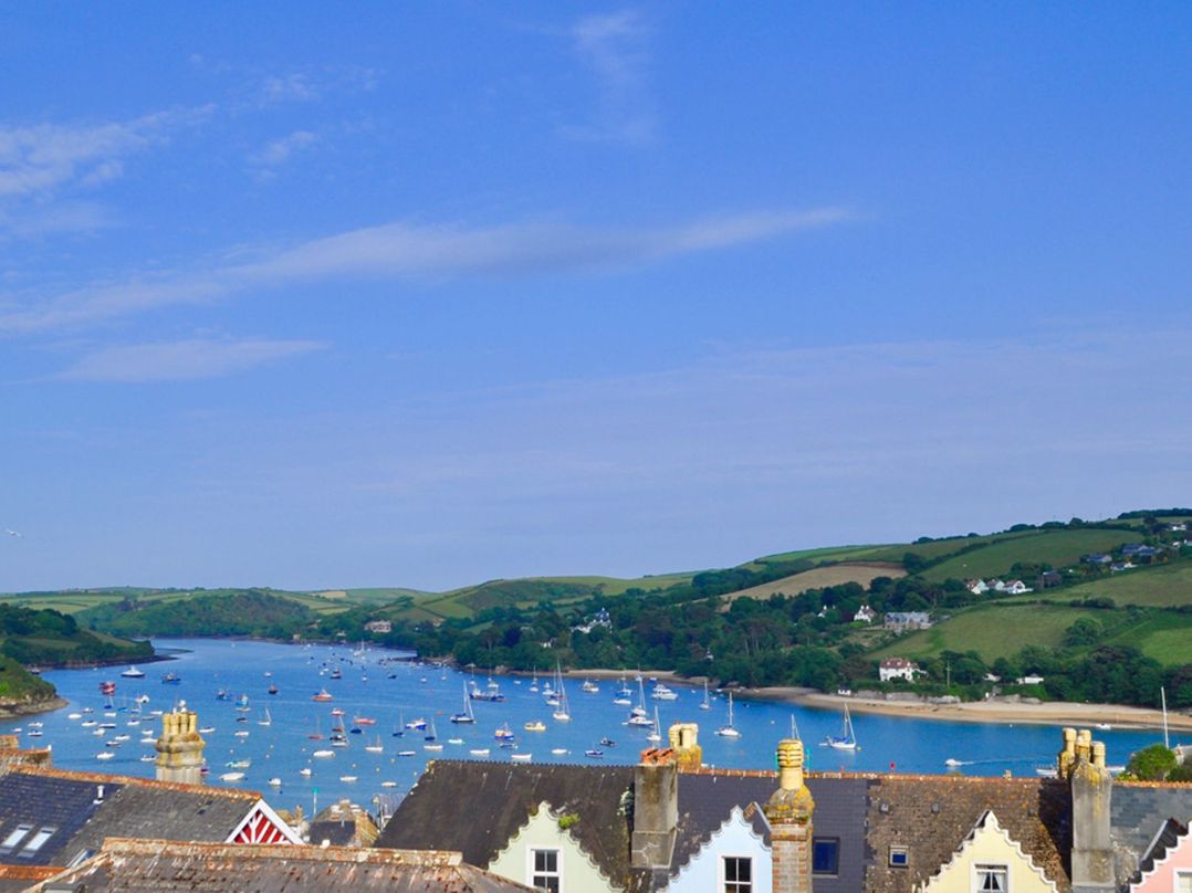 A coastal view with boats on water and houses with chimneys in the foreground at Leylands in Salcombe