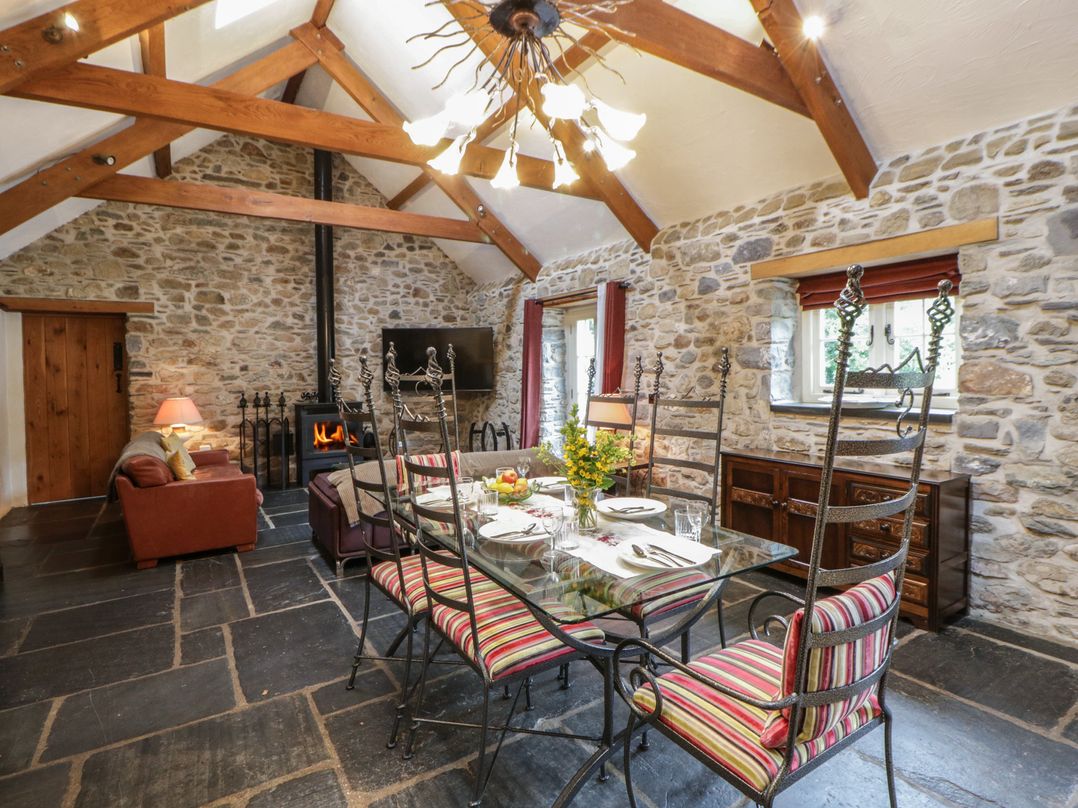 A living room with a dining table and chairs at St Dogwells Barn near Wolfscastle