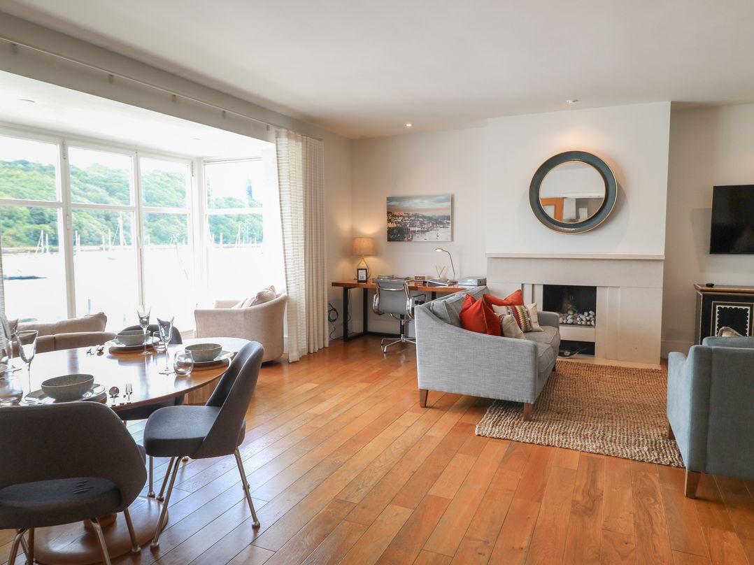 A living room with a table and chairs at 22 Dart Marina in Dartmouth