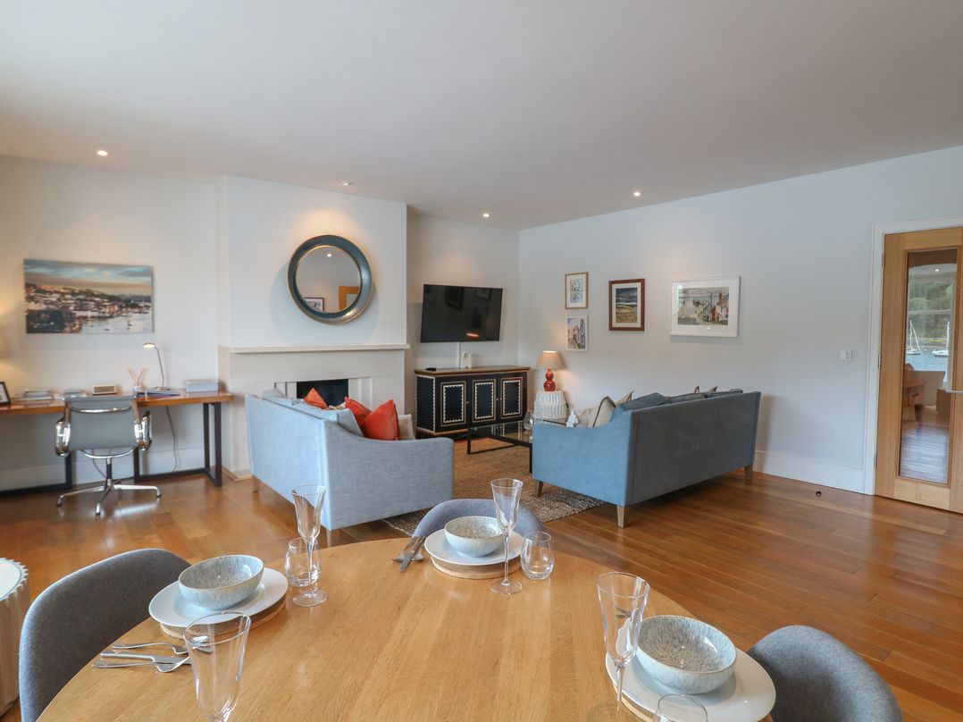 A living room with a sofa, television and desk at 22 Dart Marina Dartmouth