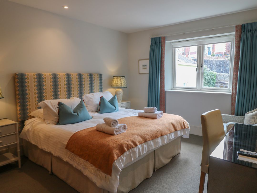 A bedroom with a double bed and window at 22 Dart Marina in Dartmouth