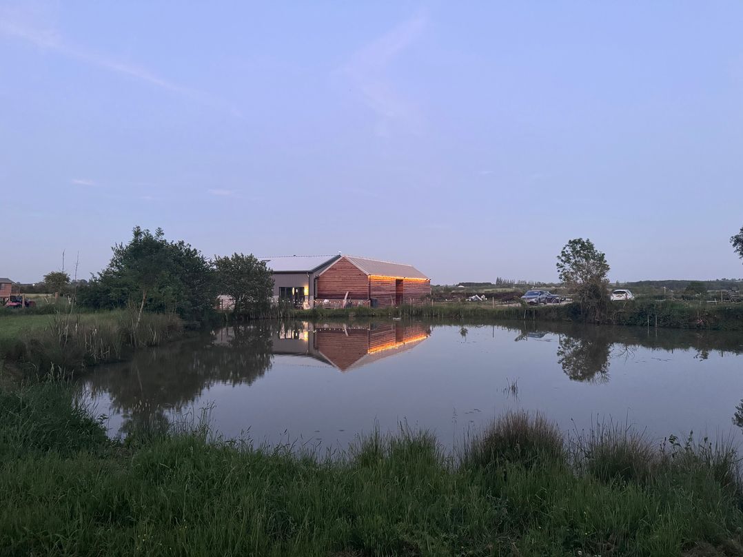 A building next to a pond at Number 3 The Barn House in Woodham