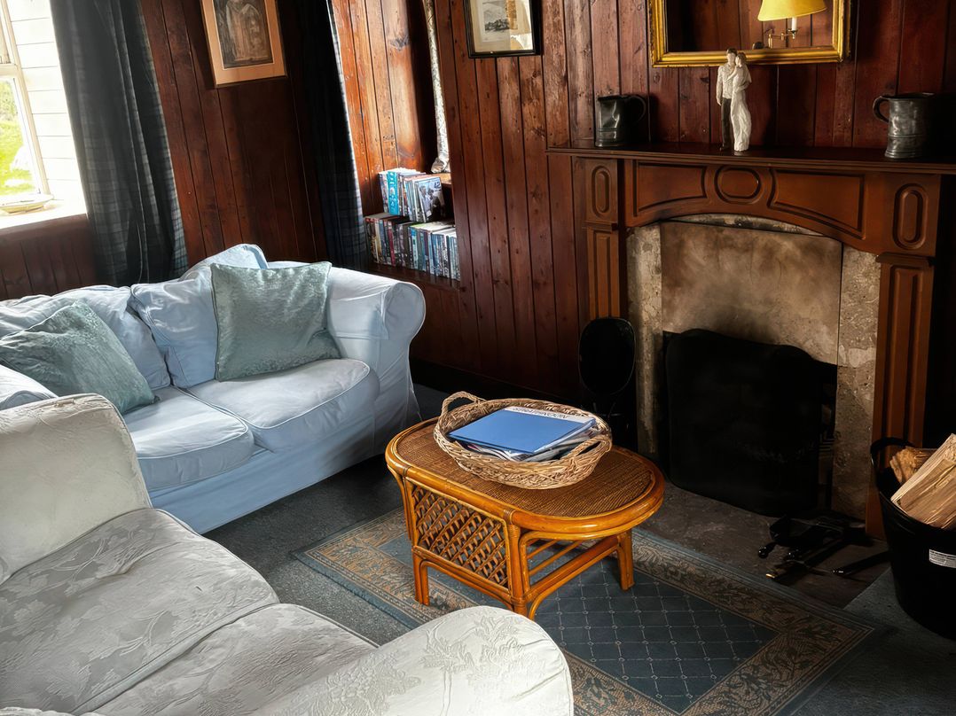 A living room with a sofa and coffee table at Strathnoon in Clune near Carrbridge