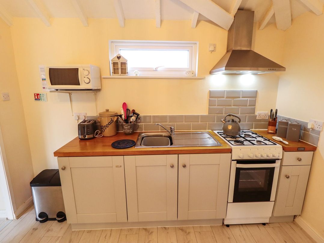 A kitchen with countertop appliances including a toaster microwave and kettle at Sunnyside in Goxhill near Barrow-Upon-Humber