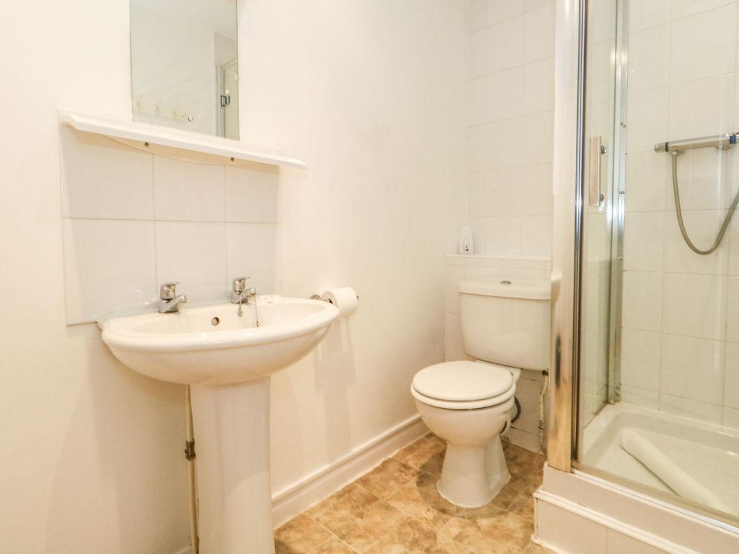 A bathroom with a sink toilet and shower cubicle at Sea Spray in Bowleaze