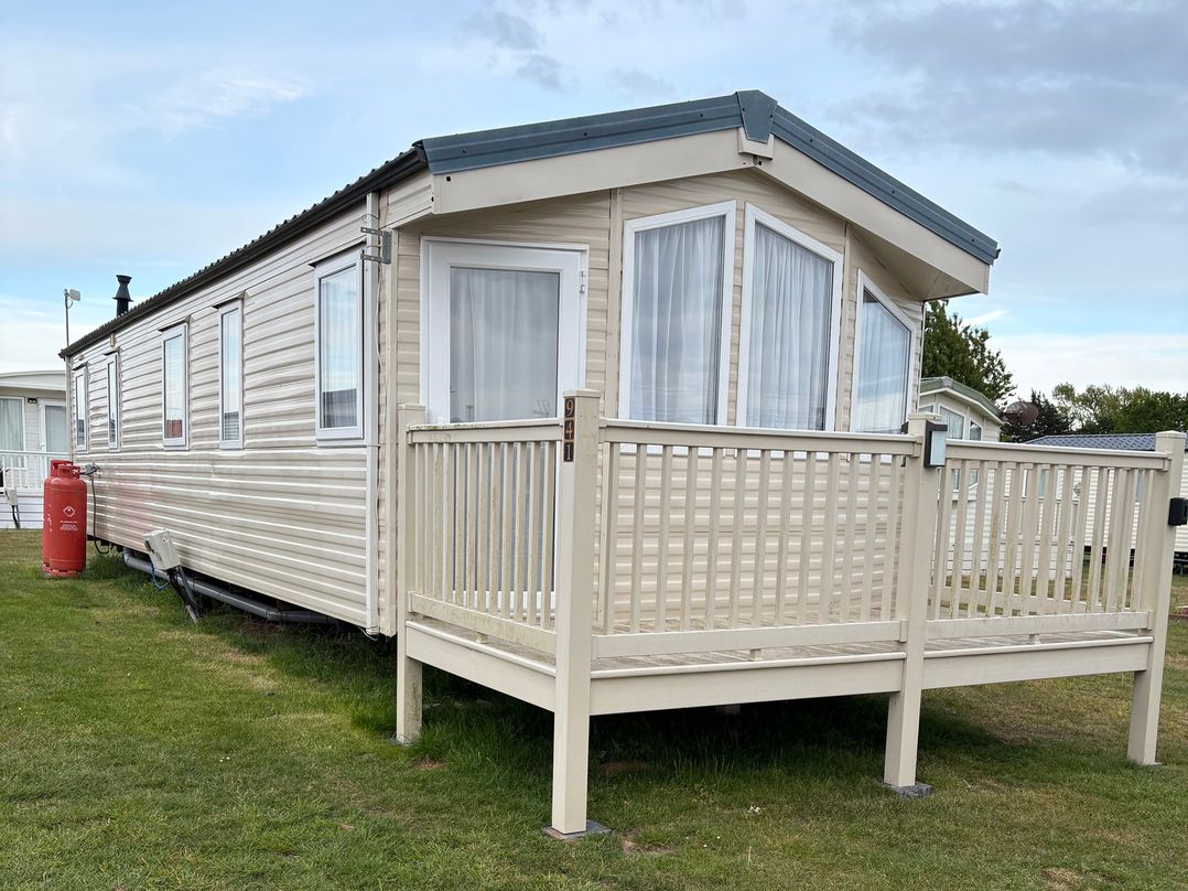 A caravan with a deck and windows at Caravan 607 Clacton-On-Sea