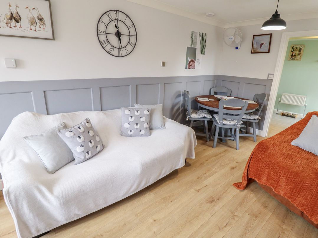 A living room with a sofa and dining table at Southfields Annex in Little Carlton near Louth