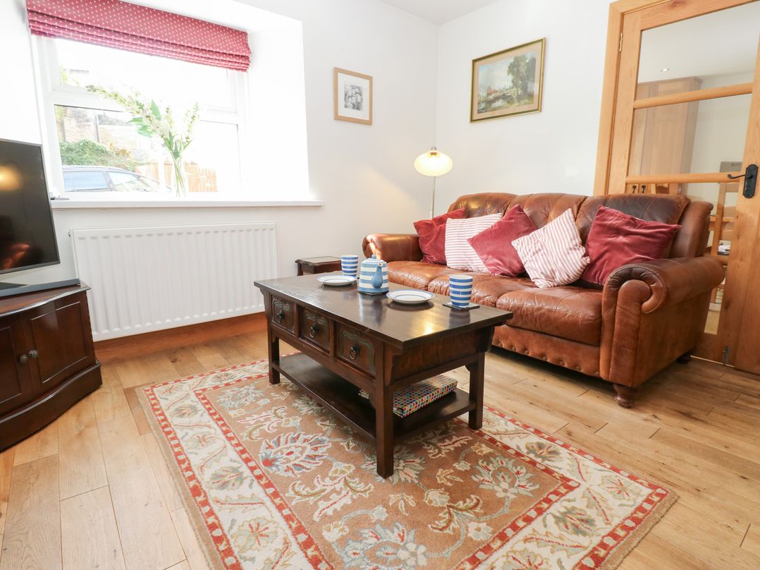 A living room with a sofa and coffee table at Bridge House