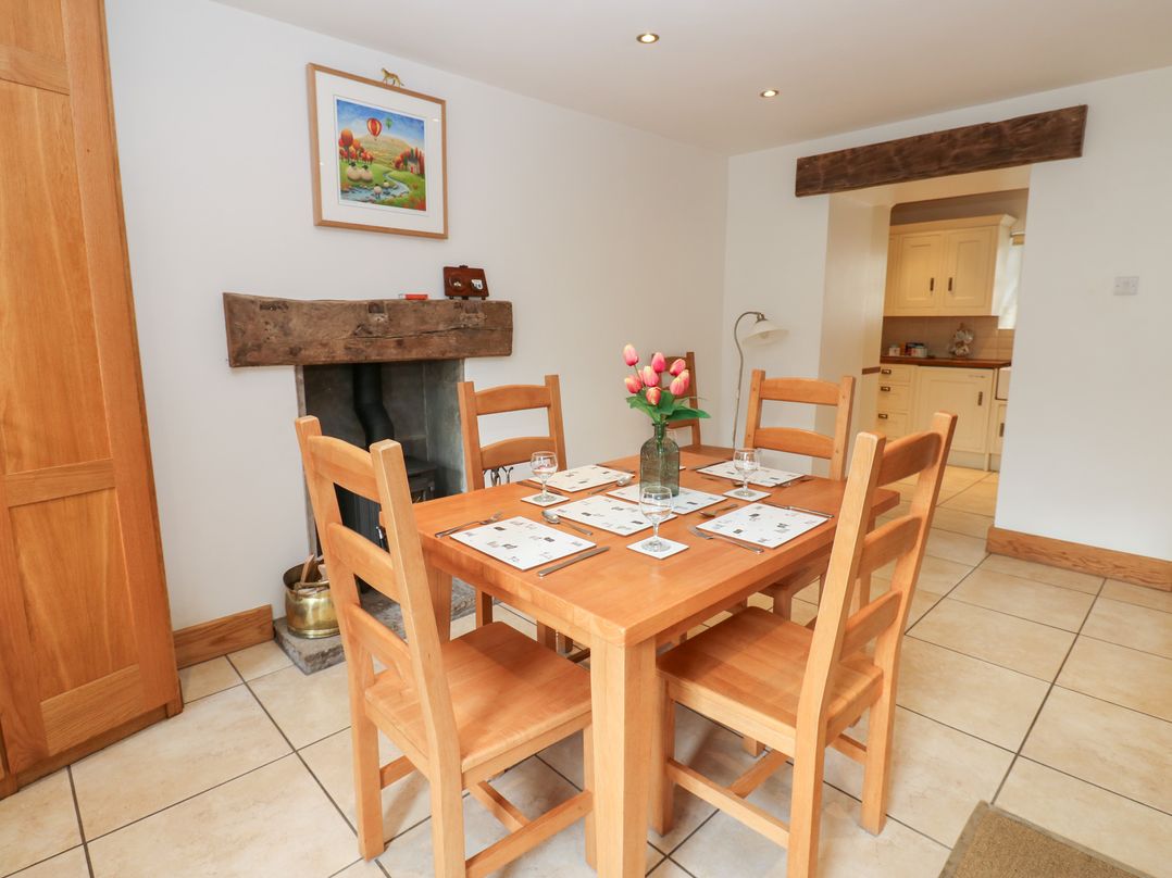 A dining room with a wooden table and chairs at Bridge House