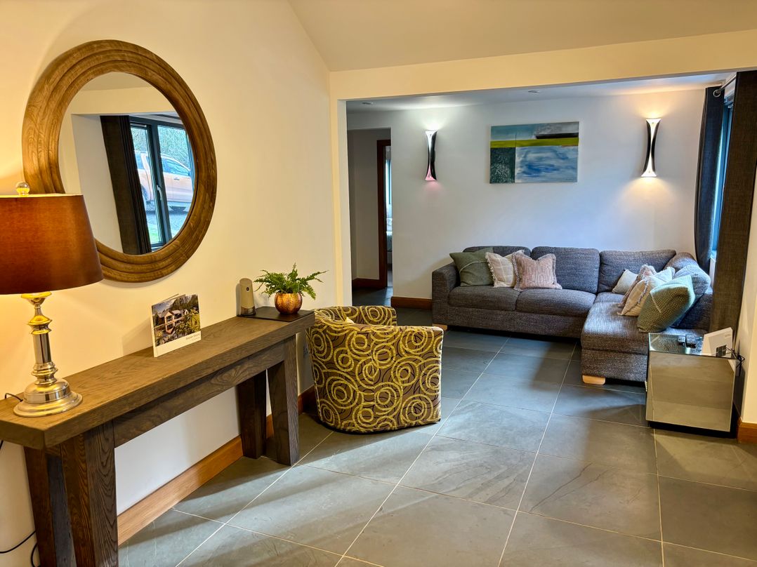 A living room with a sofa and an armchair at Bracken Ground Coniston
