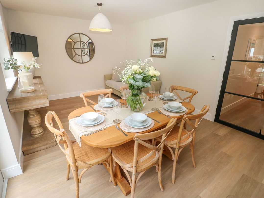 A dining room with a table set for dinner at Hafan Y Gof Newcastle Emlyn