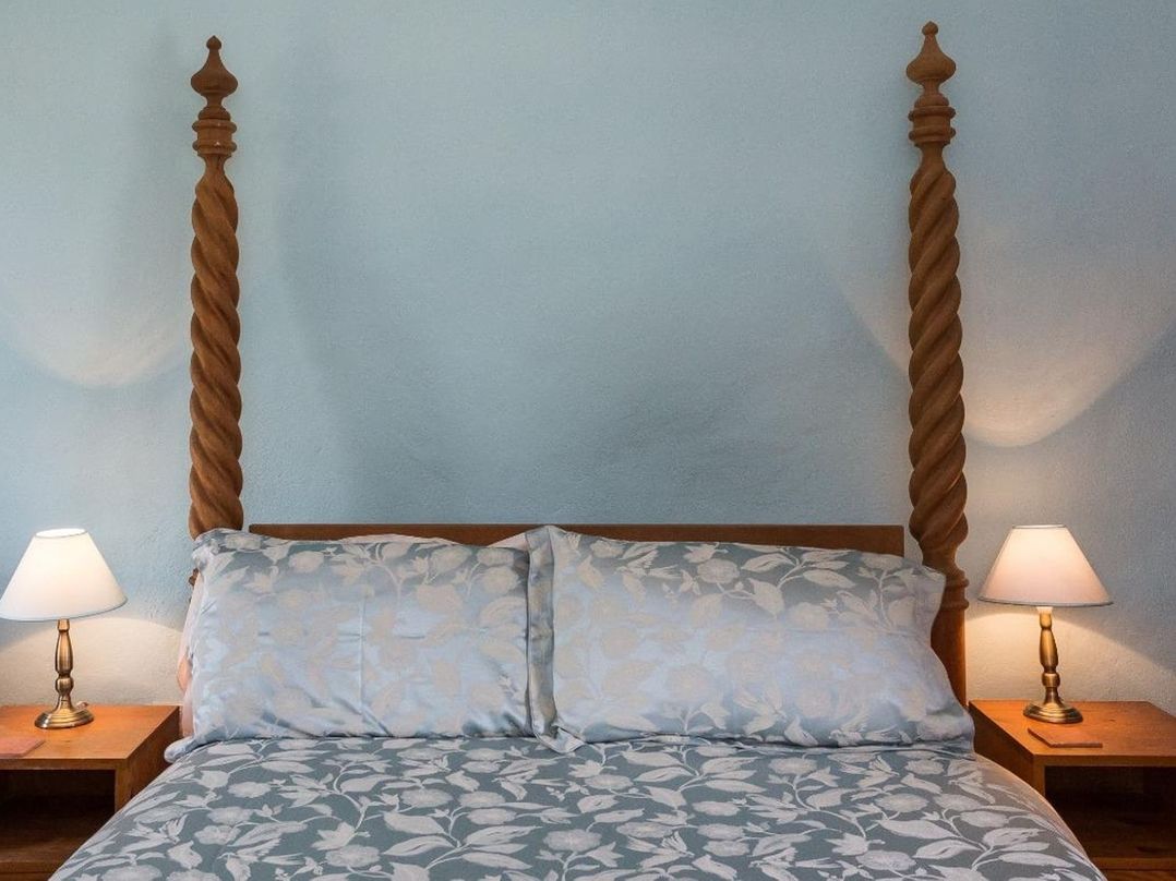 A bed with pillows and nightstands at Billy's Barn in Bradworthy