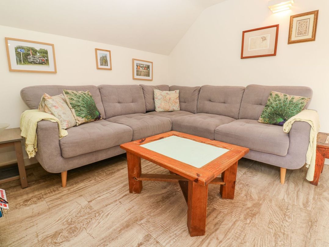 A living room with a sofa and coffee table at Five Elements Barn in Truro