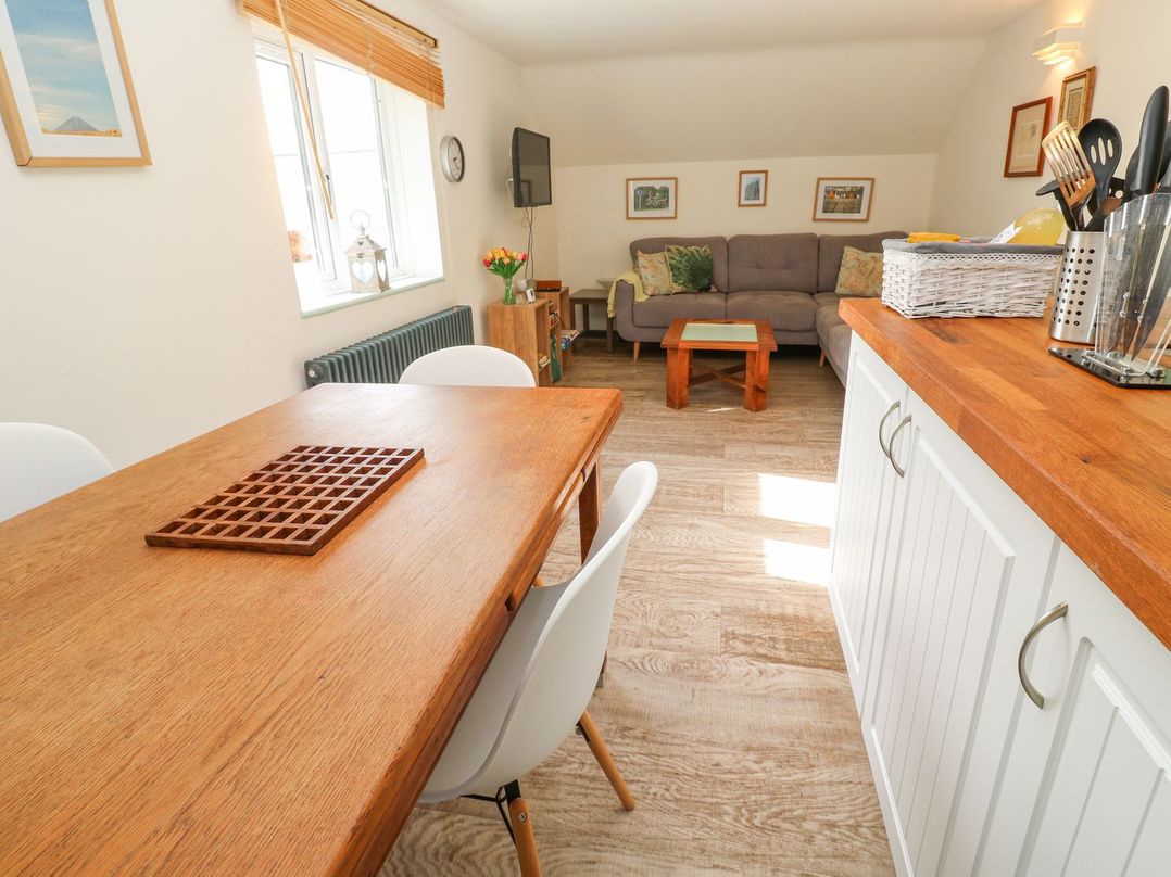 A dining area and living space with a sofa at Five Elements Barn in Truro