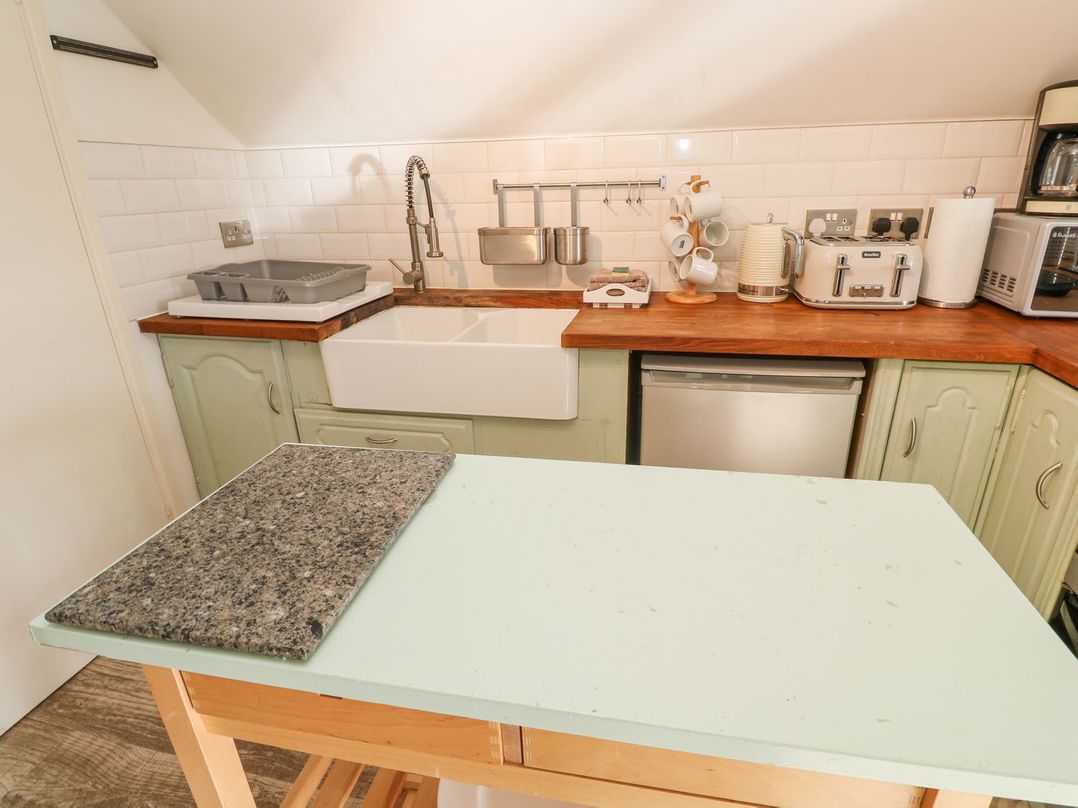 A kitchen with a sink and countertop at Five Elements Barn Truro
