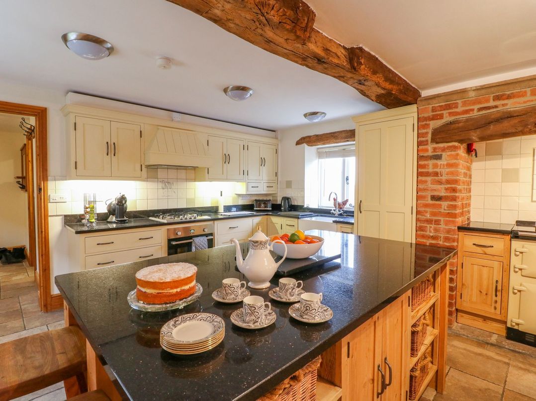 A kitchen with a stove and sink at The Barn in Wirksworth