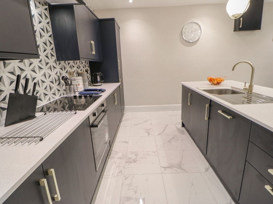 A kitchen with cabinets and a sink at 16 Seafield Terrace in South Shields