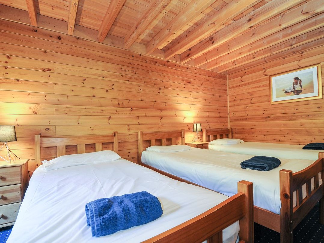 A bedroom with two beds and a nightstand at Eden in St Breward