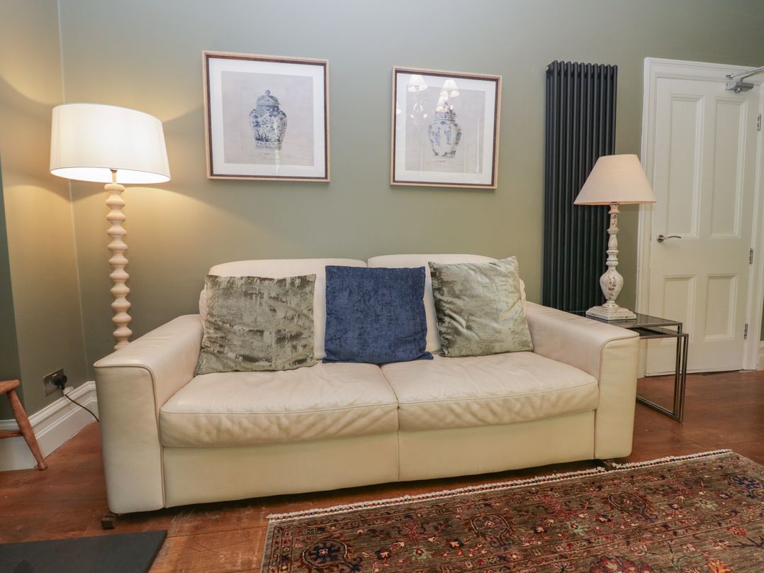 A living room with a sofa and lamp at The Boundary in Windermere