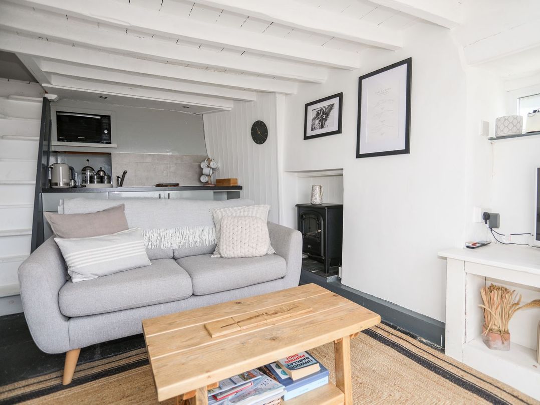 A living room with a sofa and a coffee table at The Ingle in Barmouth