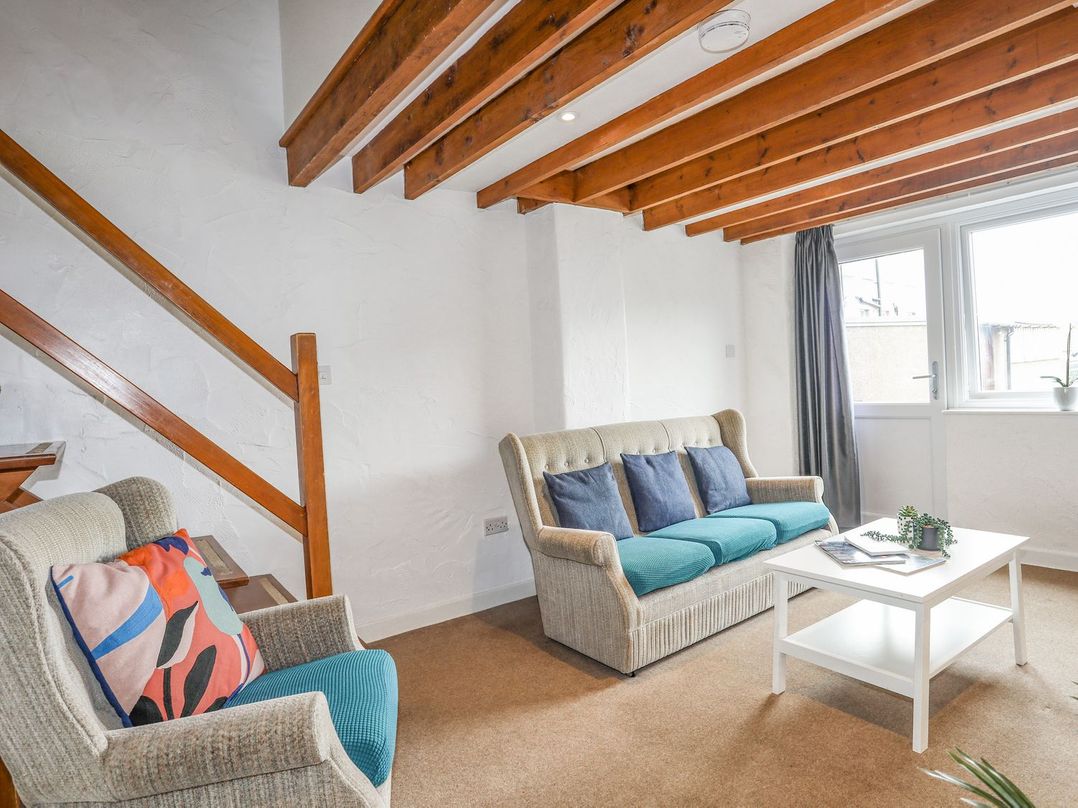 A living room with seating and coffee table at Cilan - 2 Ty'n Don in Llanengan near Abersoch