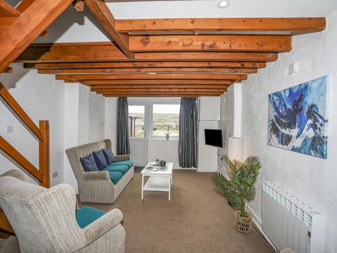 A living room with a sofa and coffee table at Cilan - 2 Ty'n Don Llanengan near Abersoch