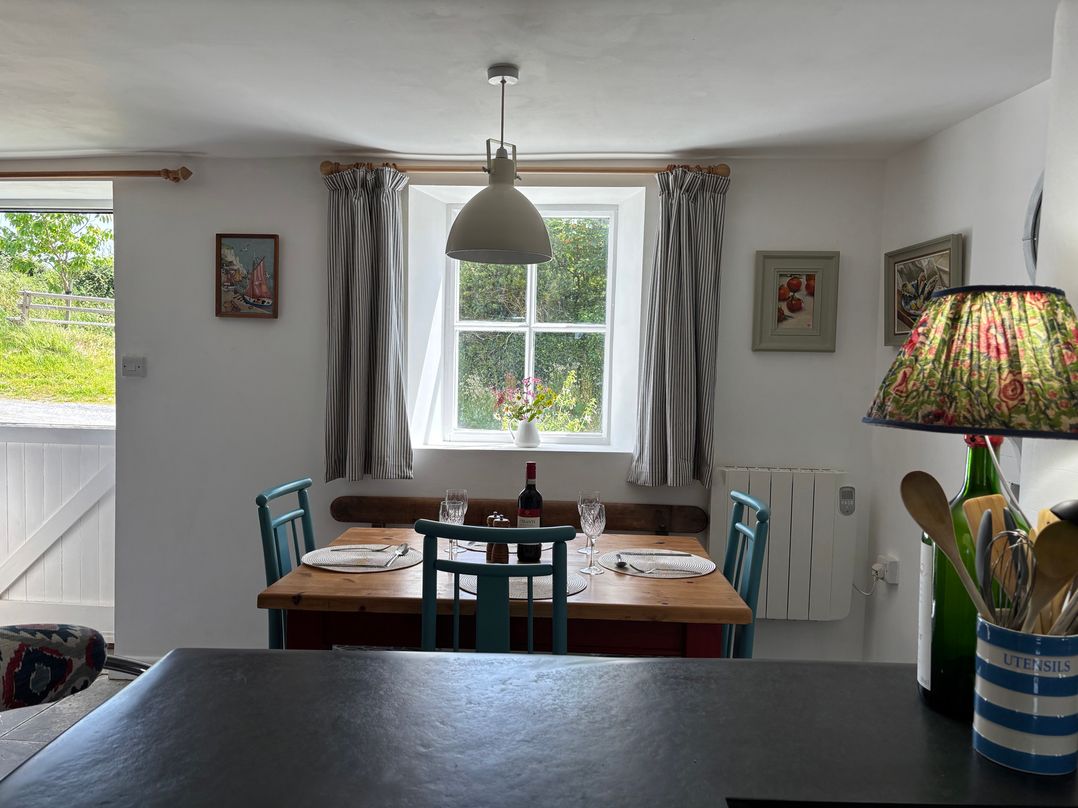 A dining room with a table and chairs at The Old Sunday School in Welcombe