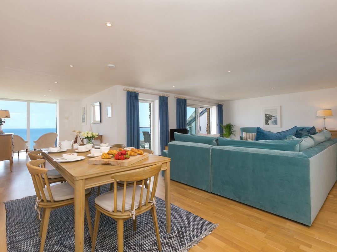 A living room with a dining area and seating at Mid Air in St. Ives