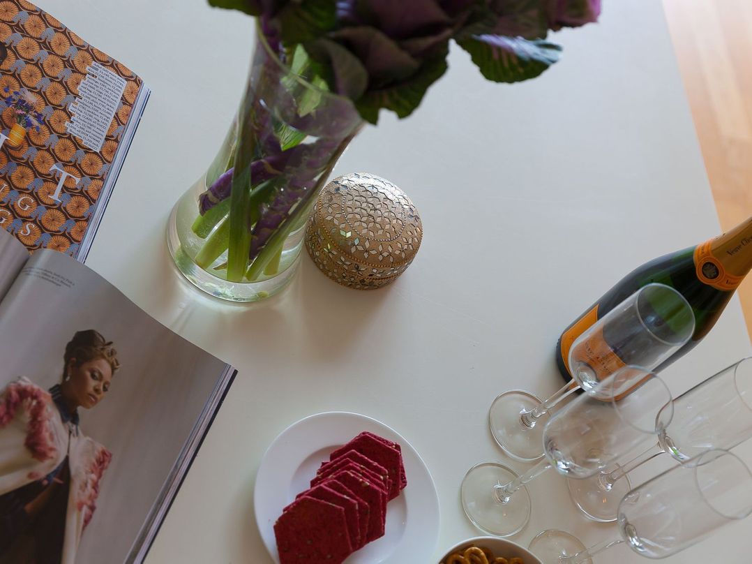 A indoor setting with flowers, snacks and champagne at Mid Air in St. Ives