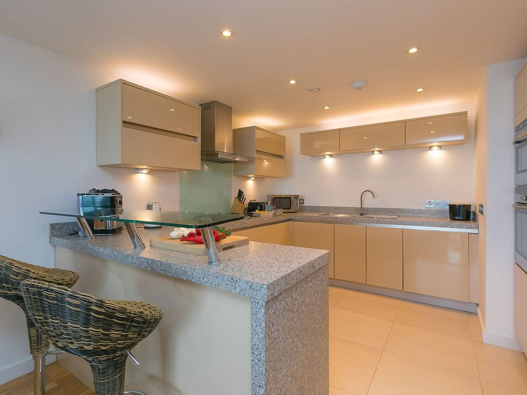 A kitchen with cabinets and a sink at Mid Air St. Ives