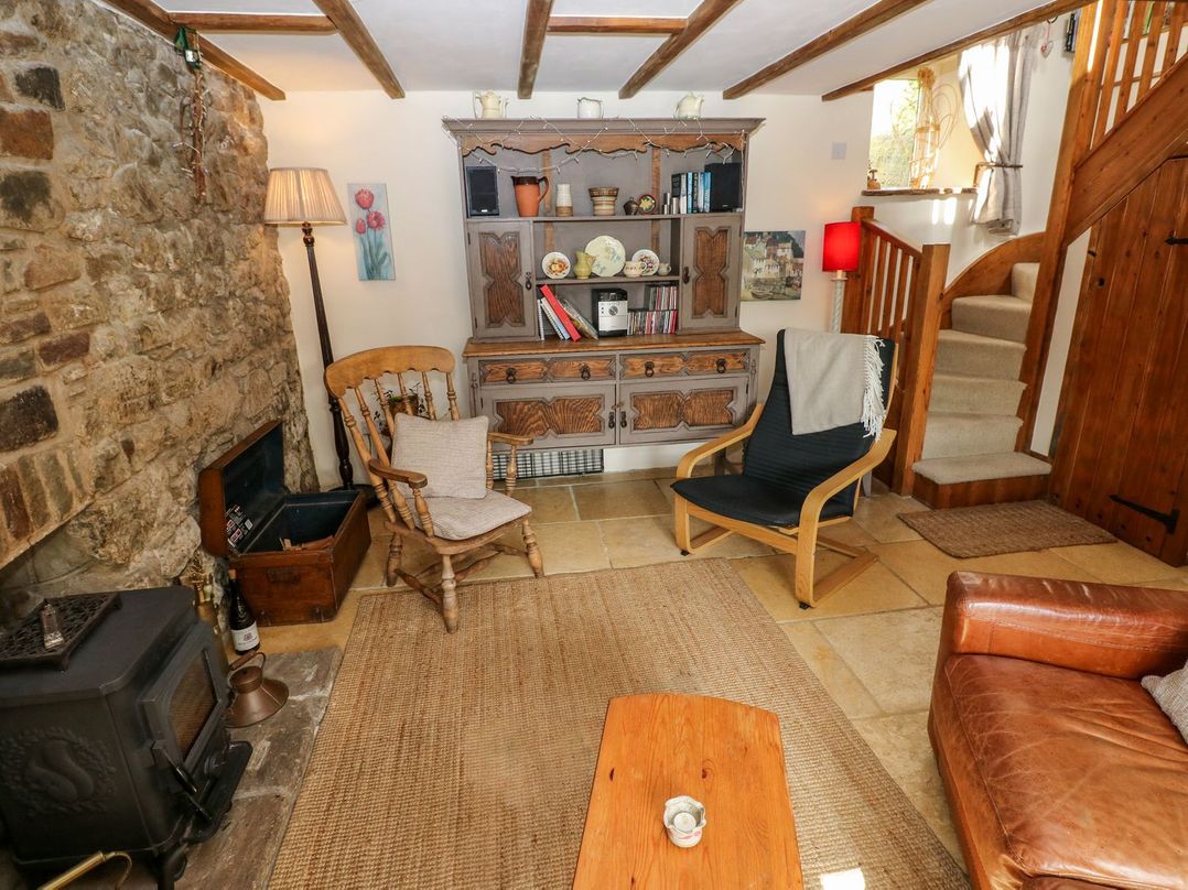 A living room with a rocking chair and a coffee table at 1 Mill Farm Cottages Narberth