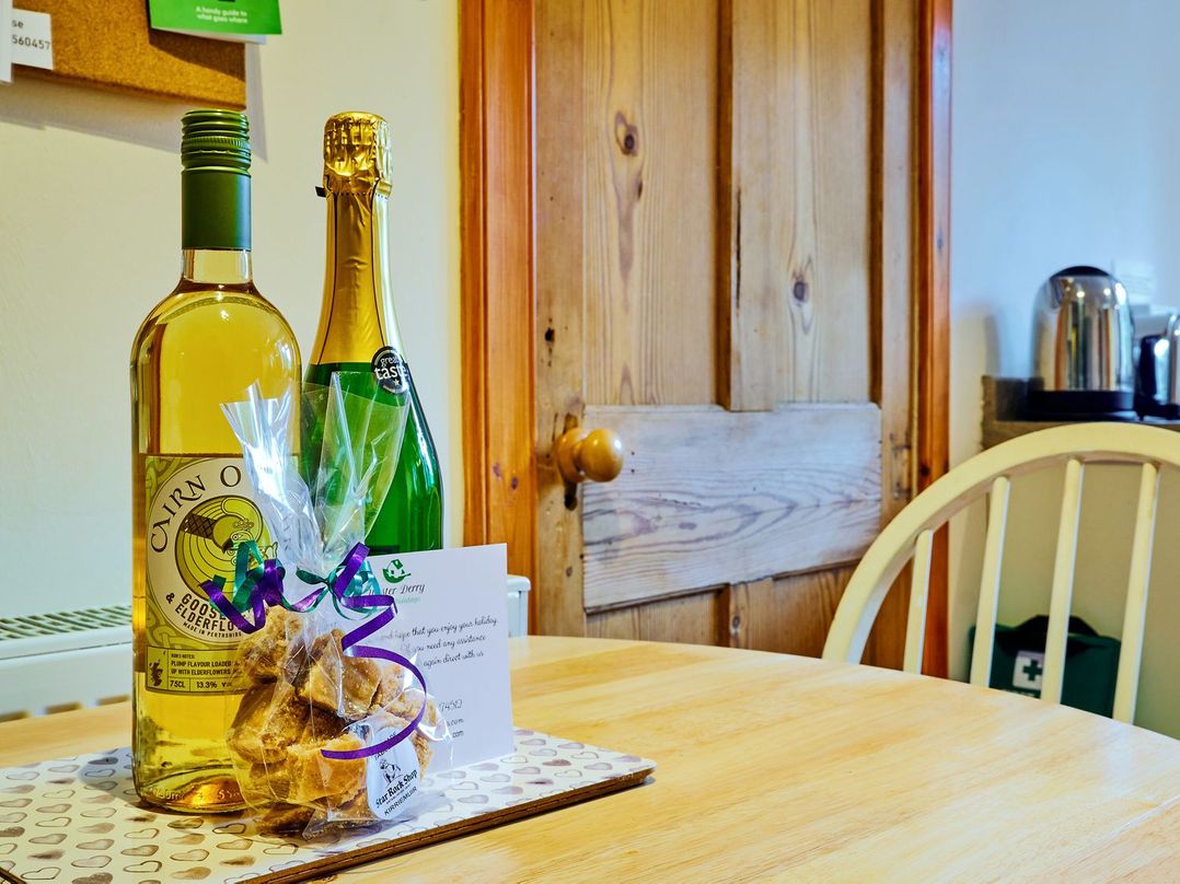 Bottles of wine and a gift on a table at West Lodge in Kirriemuir