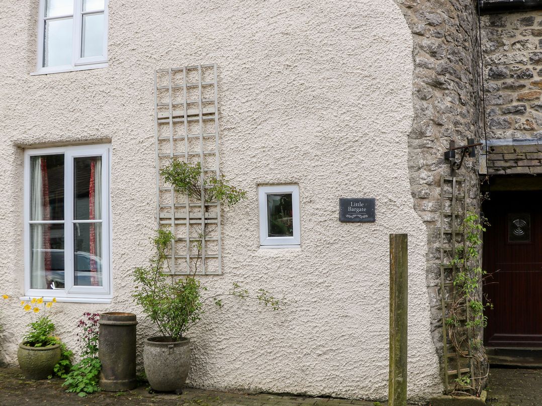 An exterior view of a house with windows and a sign at Little Bargate in Castleton, Peak District