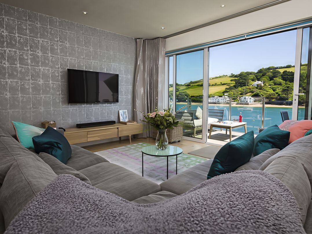 A living room with a sofa and television at Villa 8, Estura Salcombe