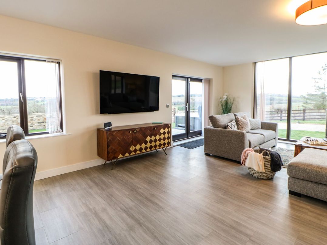 A living room with furniture including a sofa and television at High Church Hill in Durham