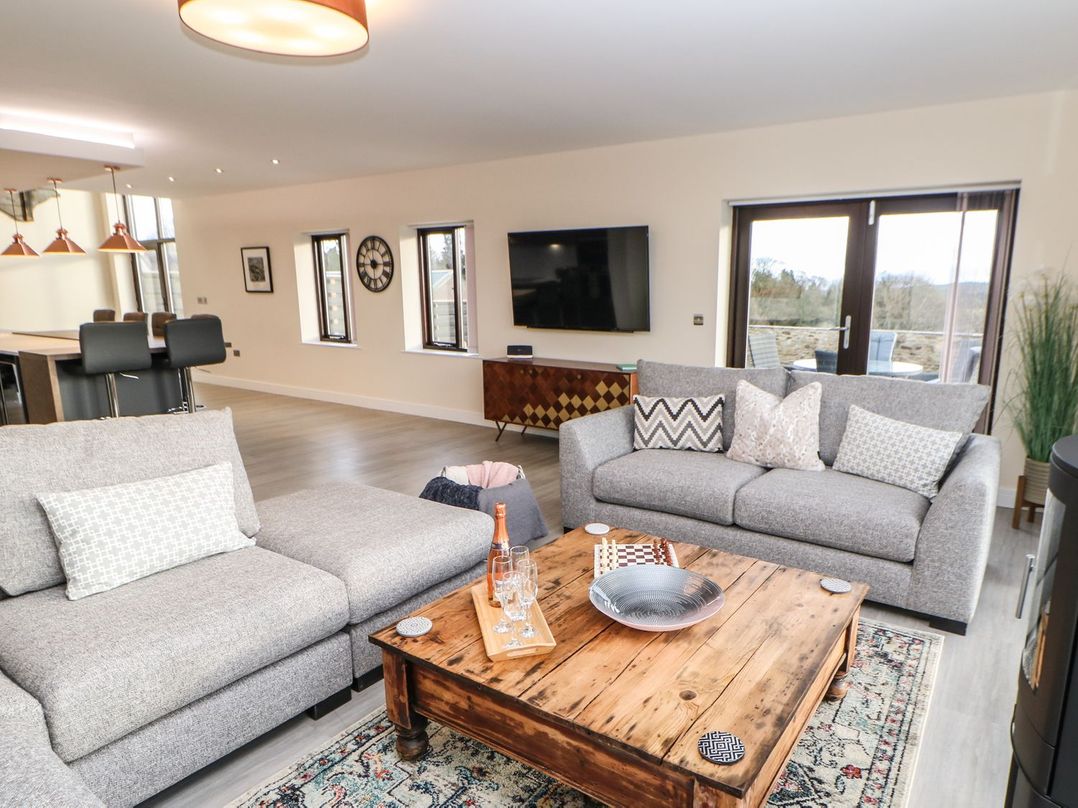 A living room with a sofa, coffee table, and television at High Church Hill in Durham