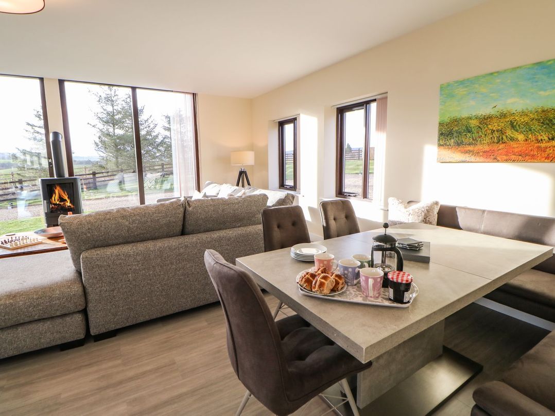 A living room with a sofa and dining table at High Church Hill in Durham