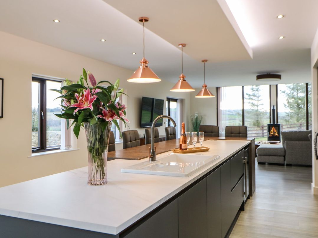 A kitchen with a large island and dining area at High Church Hill in Durham