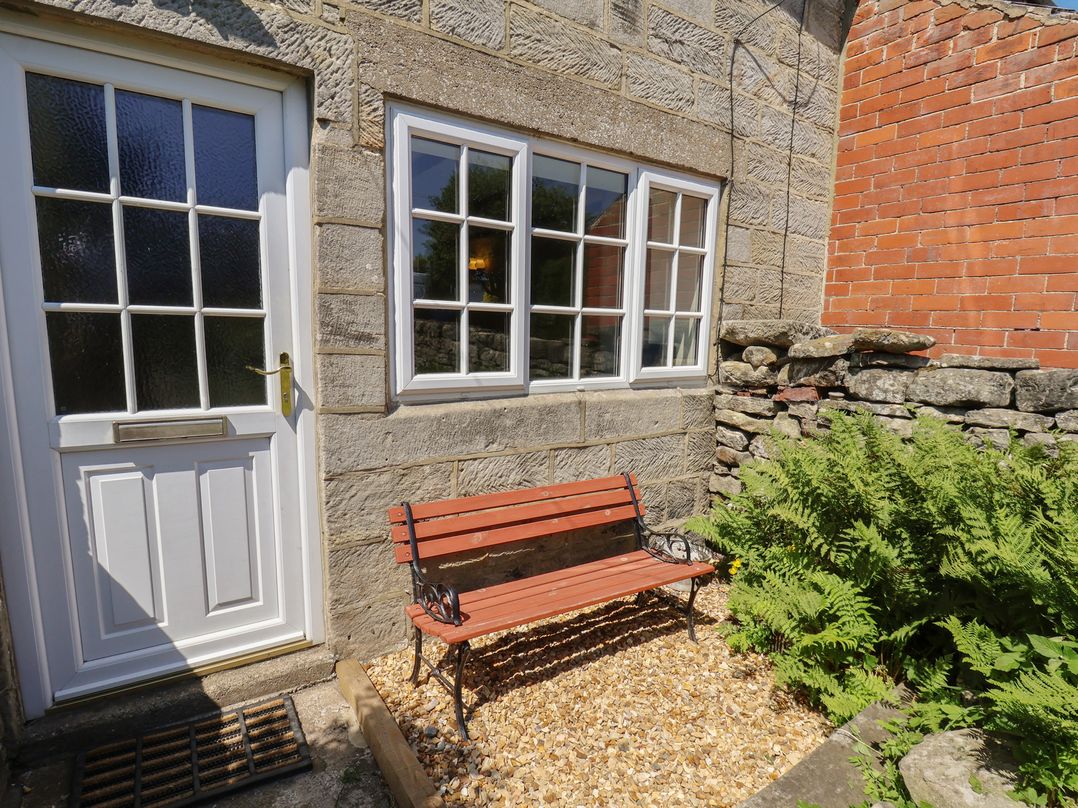 An outdoor area with a bench and plants at 4 Lilac Cottages Ainthorpe