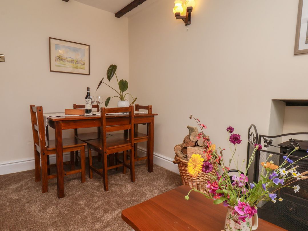 A dining room with a table and chairs at 4 Lilac Cottages Ainthorpe