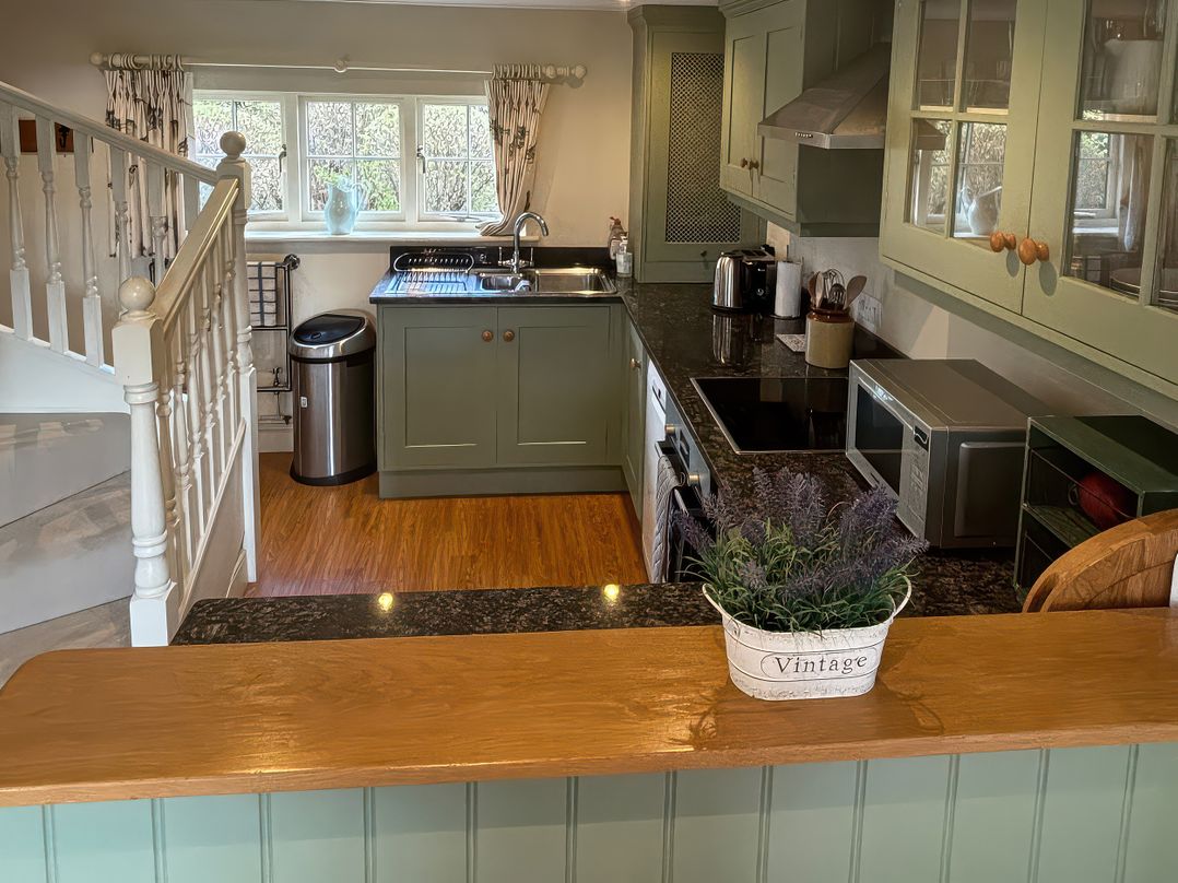 A kitchen with cabinets, sink, and appliances at New Barn in Broad Chalke