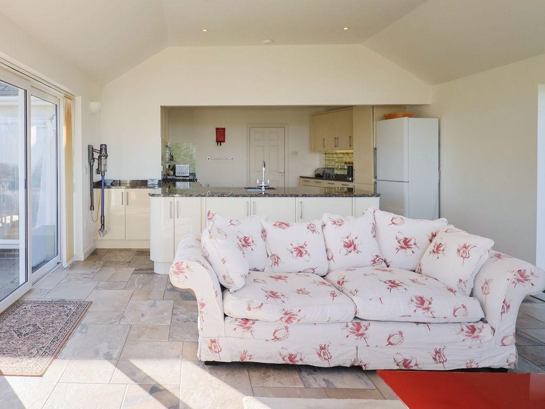 A snug with a sofa and kitchen island at Hawksdown in Lyme Regis