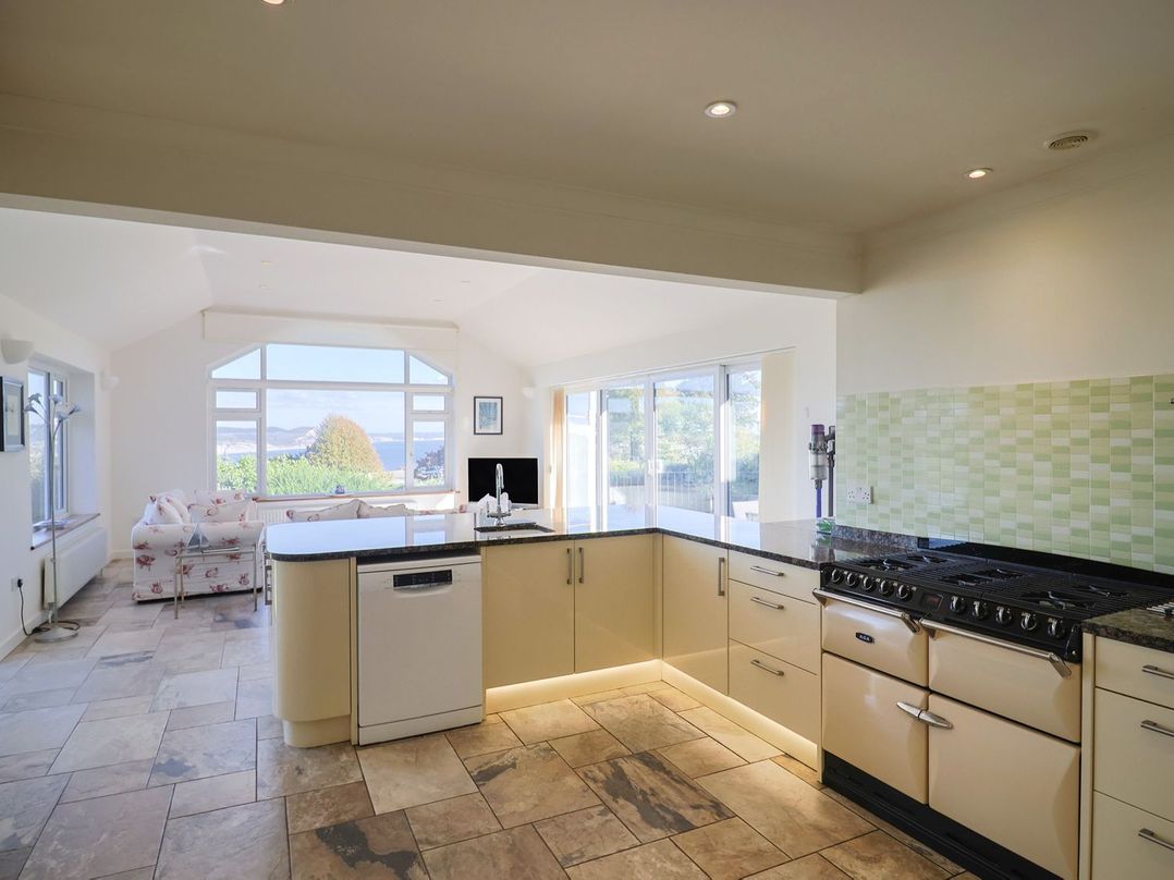 A kitchen with a stove and dishwasher at Hawksdown in Lyme Regis