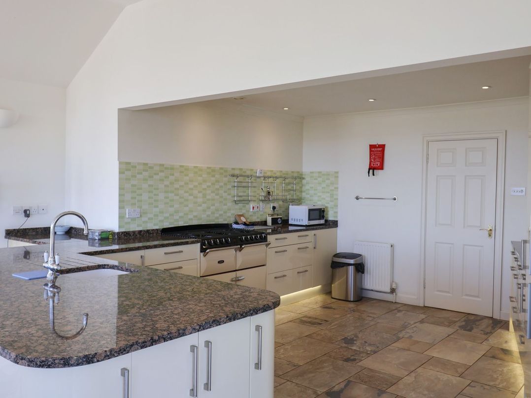 A kitchen with cabinets and appliances at Hawksdown in Lyme Regis