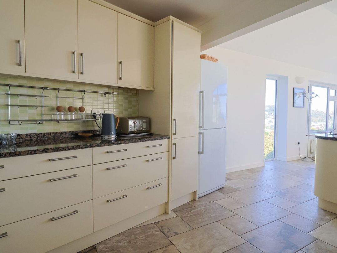 A kitchen with cabinets and appliances at Hawksdown Lyme Regis