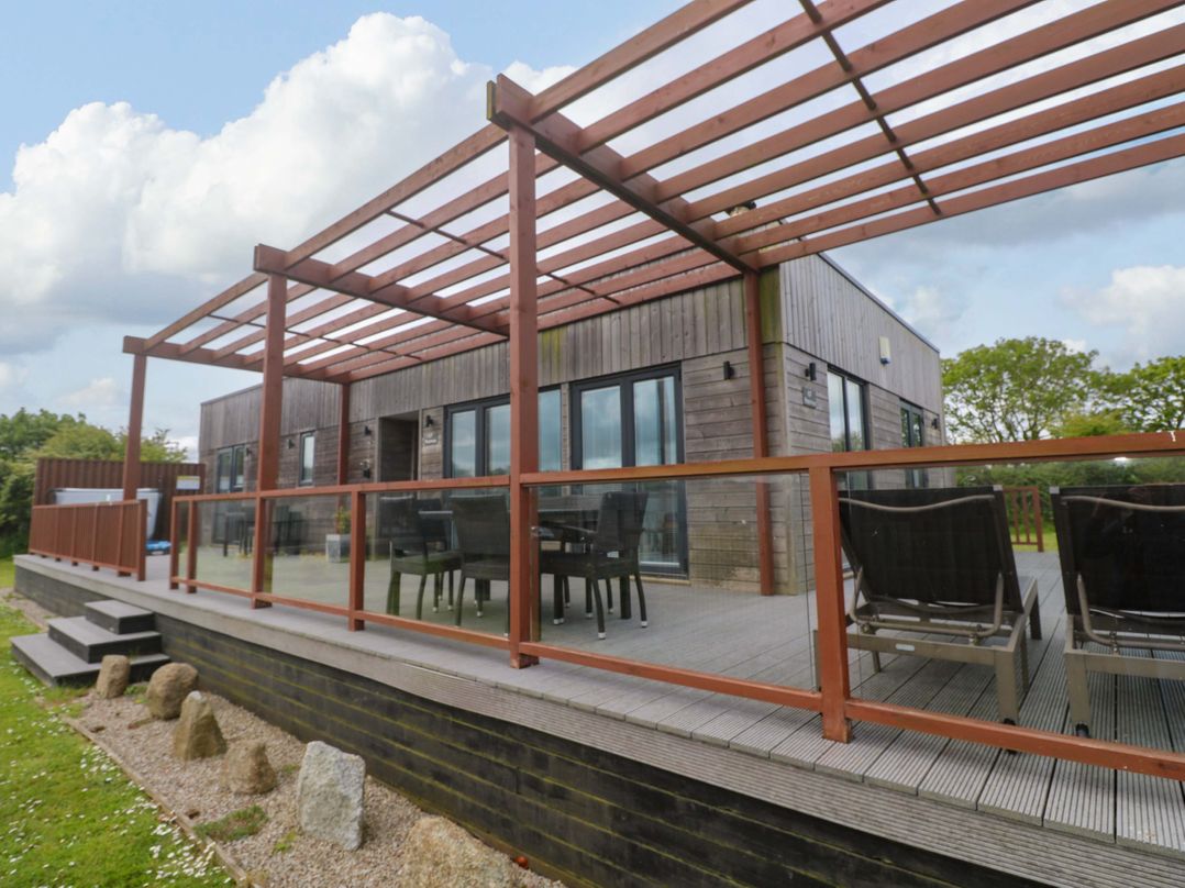 A decking area with outdoor furniture at Pentewan - 67 Portreath